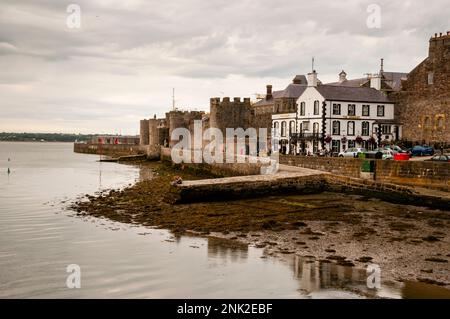 Banchina e torri tonde merlate a Caernarfon, Galles. Foto Stock