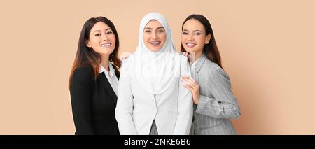 Belle donne d'affari su sfondo beige. Concetto di unità Foto Stock