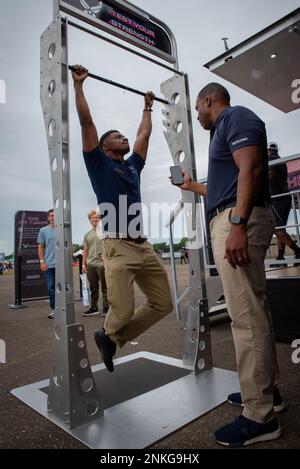 Master Sergente Efrem Swoope, reclutamento ufficio di volo capo per l'Ala Airlift 179th, parla della sua esperienza di lavoro nella Guardia Nazionale aerea mentre si esegue il test di forza in una tenda di reclutamento della Guardia Nazionale aria al Props and Pistons Festival ad Akron, Ohio il 14 agosto 2022. MSgt Swoope ritiene che il più grande vantaggio di lavorare nella Guardia Nazionale aerea sia la cultura creata dai nostri membri, mentre si prendono cura di eachother e della comunità locale. Foto Stock