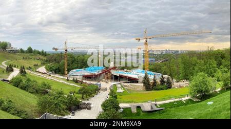 Cantiere, tre gru a torre alta e materiali da costruzione blu. Memoriale alle vittime dell'Holodomor in Ucraina. Una visione della costruttio Foto Stock