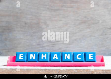 Piastrella lettera dell'alfabeto con la parola migliora in rack di colore rosso su sfondo di legno Foto Stock
