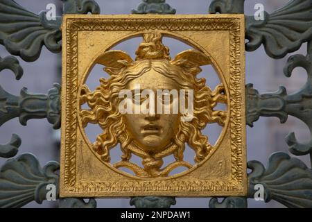 Un volto dorato, un particolare dell'originale recinzione metallica del Palazzo reale, il Palazzo reale di Torino Foto Stock