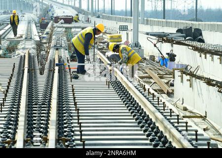 SUZHOU, CINA - 27 FEBBRAIO 2023 - i costruttori lavorano su una pista senza ballastless nel cantiere dei primi 10 marchi del fiume Nyanjiang Interci Foto Stock
