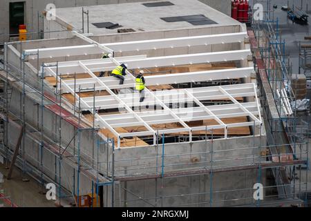 Roofter preparare una costruzione per un pozzo di luce sul tetto di un edificio commerciale. Foto Stock