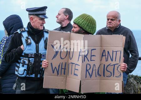 Un ufficiale della polizia del Devon e della Cornovaglia che parla con un protettore che tiene un cartello scritto a mano durante una dimostrazione organizzata dal gruppo di destra Re Foto Stock