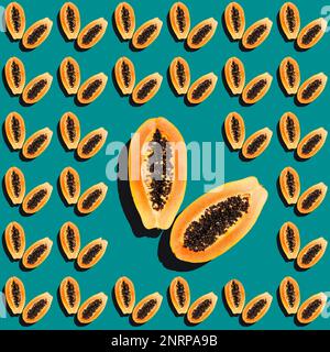 Motivo tropicale senza cuciture di metà papaya su uno sfondo blu. Modello di frutta Foto Stock