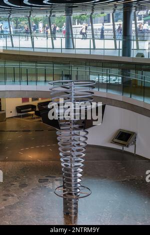 Stand di arte moderna con schermi video al London City Hall Southbank piano inferiore, mappa al piano e rampa circolare. Foto Stock