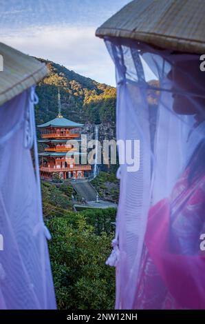 Pellegrini nel periodo Heian costumi e Nachisan Seiganto-ji (Three-Storied Pagoda), vicino a Kumano Nachi Taisha Grand Shire, Kumano Kodo, Nakahechi Foto Stock