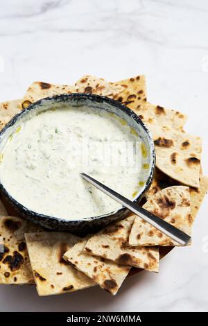 Salsa tzatziki con pita arrosto in padella. Salsa greca fatta in casa di yogurt, aneto e cetriolo. Foto Stock