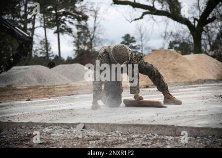 220201-N-PI330-1300 Camp Shelby, Mississippi (1 febbraio 2023) Lance CPL. Syrus Richter, assegnato al Battaglione Marines 8th Engineer Support (8th ESB), potenziando il Battaglione Naval Mobile Construction 133 (NMCB 133), elimina la polvere di calcestruzzo da un campo aereo come parte di un esercizio di riparazione di danni al campo aereo a Camp Shelby, Mississippi, 1 febbraio 2023. NMCB 133 è a Camp Shelby, Mississippi, che conduce un esercizio di addestramento sul campo che opera come parte del comando di combattimento della Marina Expeditionary che conduce la fase avanzata del piano di addestramento di preparazione alla forza (FRTP). Foto Stock