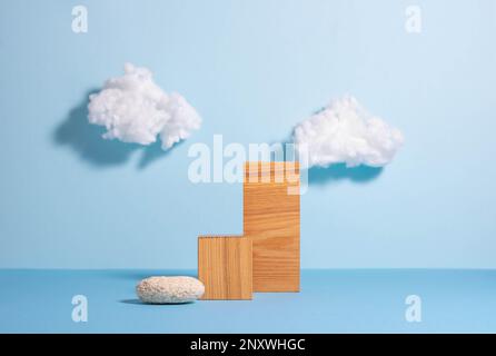 Podi in legno e vetro, sfondo blu con nuvole bianche, stile minimalista Foto Stock