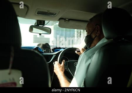 Foto dell'autista dal sedile posteriore di un taxi Foto Stock