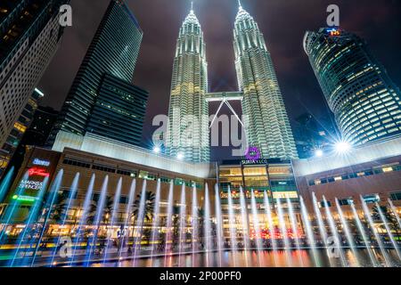 Kuala Lumpur, Malesia - Gennaio 2023: Ogni sera, le Torri Gemelle Petronas illuminano la plaza al di fuori del Centro commerciale Suria, accompagnati da una bella Foto Stock