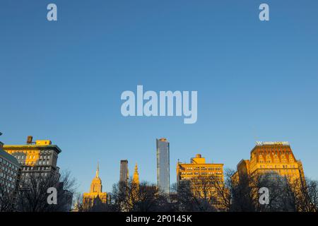 La luce del tramonto illumina gli edifici di Midtown Manhattan oltre l'Union Square Park Foto Stock