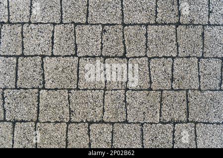 Struttura del pavimento. Sfondo astratto di lastre di pavimentazione grigie di piccola pietra, primo piano. Foto Stock