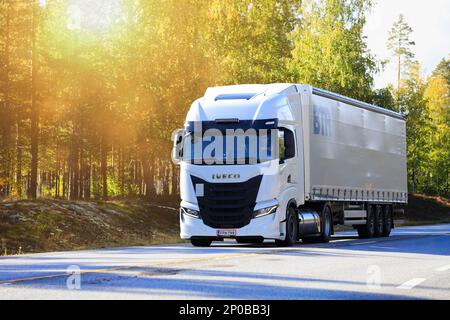 Nuovo veicolo Iveco S-Way bianco davanti al semirimorchio sull'autostrada 25 alla luce del sole del mattino. Raasepori, Finlandia. Settembre 23, 2022. Foto Stock