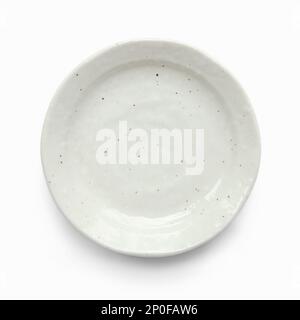 Small grey empty saucer isolated on white. Little ceramic dish of uneven, imperfect shape Foto Stock