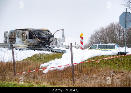 PRODUZIONE - 02 marzo 2023, Meclemburgo-Pomerania occidentale, Gützkow: Al bivio di Gützkow si trova un furgone in transito di cassa bruciato. Dopo la spettacolare rapina di un trasportatore di denaro con milioni di bottini nel Meclemburgo-Pomerania occidentale, i colpevoli sono ancora in corsa il venerdì. Foto: Str/dpa Foto Stock