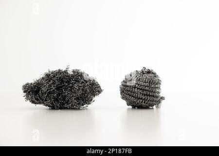 Una spugne in filo metallico usata e una nuova spugne da cucina primo piano ripresa studio isolato su bianco. Foto Stock