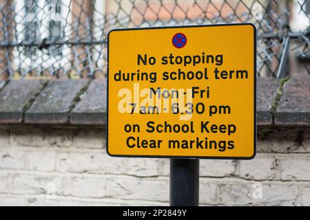 Un cartello stradale su una strada a Londra, nel Regno Unito, dice ai conducenti di non parcheggiare fuori dalla scuola, mantenendo le indicazioni chiare per la scuola. Foto Stock