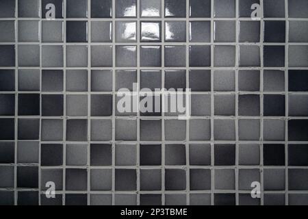 Parete di tessere mosaico grigio chiaro e grigio scuro Foto Stock
