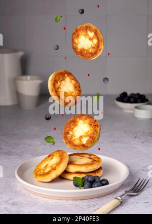 Cibo fotografia di frittelle, formaggio casolare, mirtilli, marmellata, colazione, brunch, menta, mattina Foto Stock