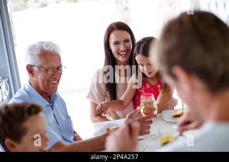 Condividere un pasto con i propri cari. una famiglia multi-generazionale che ha un pasto insieme. Foto Stock