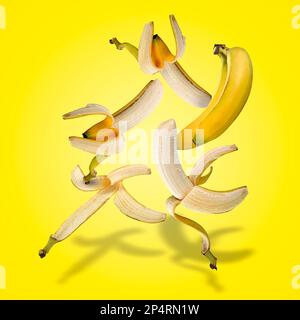 Set galleggiante di banane con ombre su gradiente giallo Foto Stock