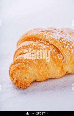 Croissant con caramelle allo zucchero, colazione tipica del mattino. Sfondo bianco. Foto Stock