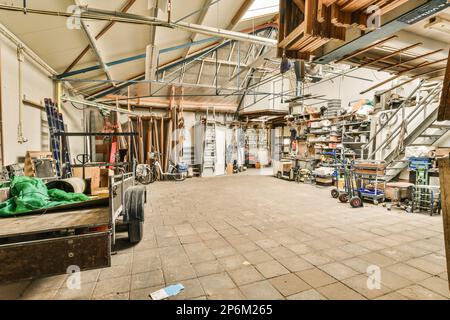 l'interno di un edificio che viene utilizzato come officina per la lavorazione del legno e altre cose su cui lavorare Foto Stock