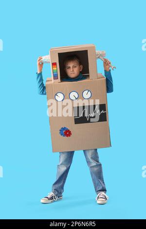 Bambino in costume robot di cartone su sfondo blu Foto Stock