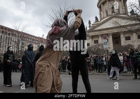 8 marzo 2023, Berlino, Germania: Oggi, il 8 marzo 2023, molti manifestanti si sono riuniti a Berlino per partecipare a varie proteste ed eventi per la Giornata internazionale della donna. Tra questi vi erano donne e uomini iraniani che hanno sensibilitato ai diritti delle donne in Iran. Si sono Uniti all'appello globale per la parità di genere e hanno chiesto libertà e uguaglianza per tutte le donne. A Gendarmenmarkt, una rappresentazione teatrale simboleggia la soppressione dei diritti delle donne da parte del regime talebano in Afghanistan. Durante lo spettacolo teatrale a Gendarmenmarkt, le donne erano legate e avevano la loro libertà tolta. Una donna era forci Foto Stock