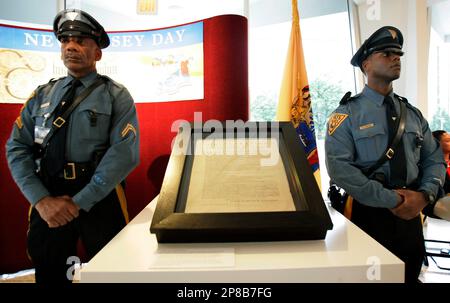 Two New Jersey state troopers stand next one of only 25 know original Dunlap imprint copies of the Declaration of Independence Wednesday, June 24, 2009, in Trenton, N.J., during an observance of the 345th anniversary of the state's founding as a British proprietary colony. Printed on July 4, 1776, this is the only copy that tours the country. New Jersey earned the opportunity to display the rare copy of the Declaration thanks to the widespread participation of Garden State students in voter education and mock election activities last fall. (AP Photo/Mel Evans)