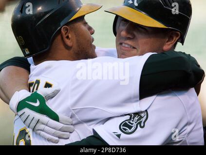 Oakland Athletics' Jack Cust, right, gets a handshake from third base coach  Tony DeFrancesco after Cust hit a two-run home run off Texas Rangers' Eric  Hurley in the first inning of a