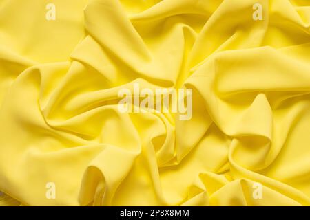 Tessuto semplice giallo sbriciolato come primo piano dello sfondo Foto Stock
