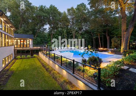 L'esterno di una casa ristrutturata con nuovi giardini, piantagioni e una piscina Foto Stock