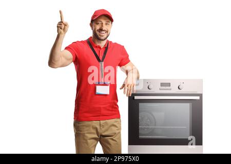 Venditore appoggiato su un forno e che punta isolato su sfondo bianco Foto Stock