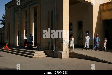 Afghan medical workers enjoy a break in front of the emergency entrance of the Spinza hospital in Kunduz, northern Afghanistan, Sunday, Sept. 21, 2008. The Spinza hospital was built in Kunduz about 50 years ago and is the oldest hospital serving in the Kunduz area.(AP Photo/Anja Niedringhaus)