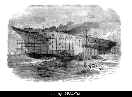 L'edificio di HMS Warrior, una fregata blindata a vapore da 40 cannoni costruita per la Royal Navy nel 1859–1861 presso la Thames Ironworks di Blackwall, Londra, Inghilterra. Il guerriero e la nave sorella HMS Black Prince furono le prime navi da guerra rivestite di corazza e di ferro, e furono costruite in risposta al lancio della Francia nel 1859 della prima nave da guerra oceanica, il Gloire con scafo di legno. Foto Stock