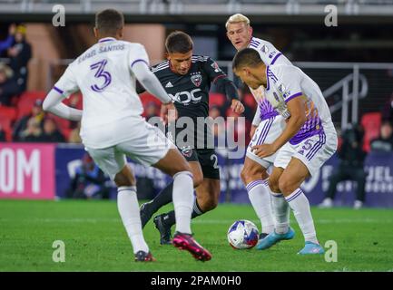 WASHINGTON, DC, USA - 11 MARZO 2023: Rafael Santos, difensore di Orlando City SC (3) e centrocampista Cesar Araujo 95), si difende contro DC United Forward Yamil Asad (22) durante una partita MLS tra D.C United e Orlando City SC, il 11 marzo 2023, presso Audi Field, a Washington, CC. (Foto di Tony Quinn-Alamy Live News) Foto Stock