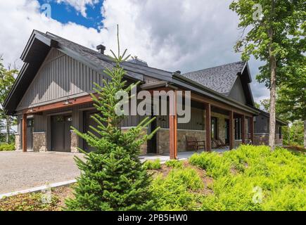 Taglio pietra e legno di carbone tavola con finitura nera struttura in legno ibrido casa in estate. Foto Stock