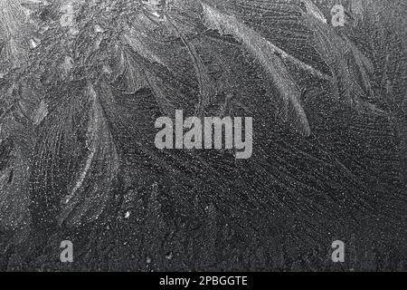 Frost con motivi come piuma sul cofano della mia auto all'inizio di marzo Foto Stock