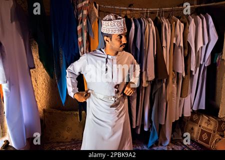 Uomo che indossa il tradizionale abito da dishasha, Bait al Safah, al Hamra, Oman Foto Stock