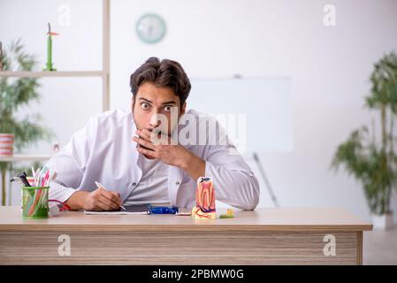 Giovane dentista che lavora in clinica Foto Stock