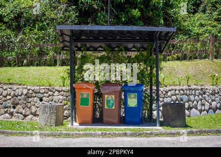 Contenitori separati per contenitori in alluminio, vetro, bottiglie in plastica e rifiuti di carta. Separare i rifiuti per un facile riciclaggio Foto Stock