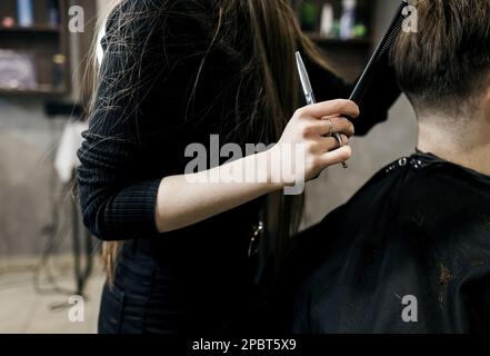 forbici da taglio per capelli da uomo in un salone di bellezza. tagliare i capelli alle forbici del barbiere Foto Stock