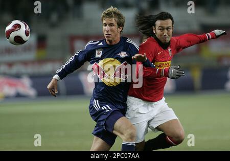 Mark Janko from Red Bull Salzburg and Marcus Tulio Tanaka from the Japanese soccer club Urawa Red Diamonds, from left, challenge for the ball during their Bulls Cup match in Salzburg, Austria, on Tuesday, Feb. 13, 2007. (AP Photo/Kerstin Joensson)