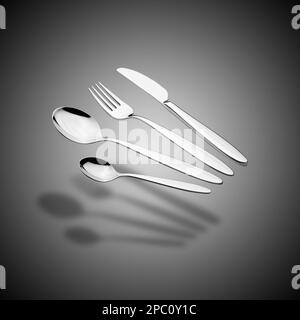 Set Silverware galleggiante con forchetta, coltello e cucchiai su sfondo grigio sfumato Foto Stock