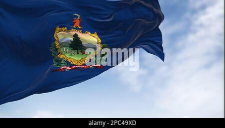 La bandiera dello stato del Vermont sbatte nel vento in una giornata limpida. Stemma e motto libertà e unità su sfondo blu. 3D rappresentazione dell'illustrazione. R Foto Stock