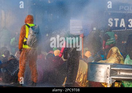 Un camion di cannone spara l'acqua verso i dimostranti durante la dimostrazione. Extinction Rebellion ha organizzato un blocco sull'autostrada A12 a l'Aia questo pomeriggio, nonostante un divieto da parte del comune. La polizia è intervenuta dopo la scadenza delle 5. Intorno alle 5:10 la polizia cominciò a rompere la manifestazione. Il cosiddetto “getto di rana” del canone d’acqua tedesco è stato utilizzato per disperdere i manifestanti durante il loro sit-down; questo ha avuto un effetto molto scarso poiché la maggior parte sono stati preparati per un evento del genere. Secondo Extinction Rebellion, più di 3.000 manifestanti sono stati coinvolti nel blocco Foto Stock